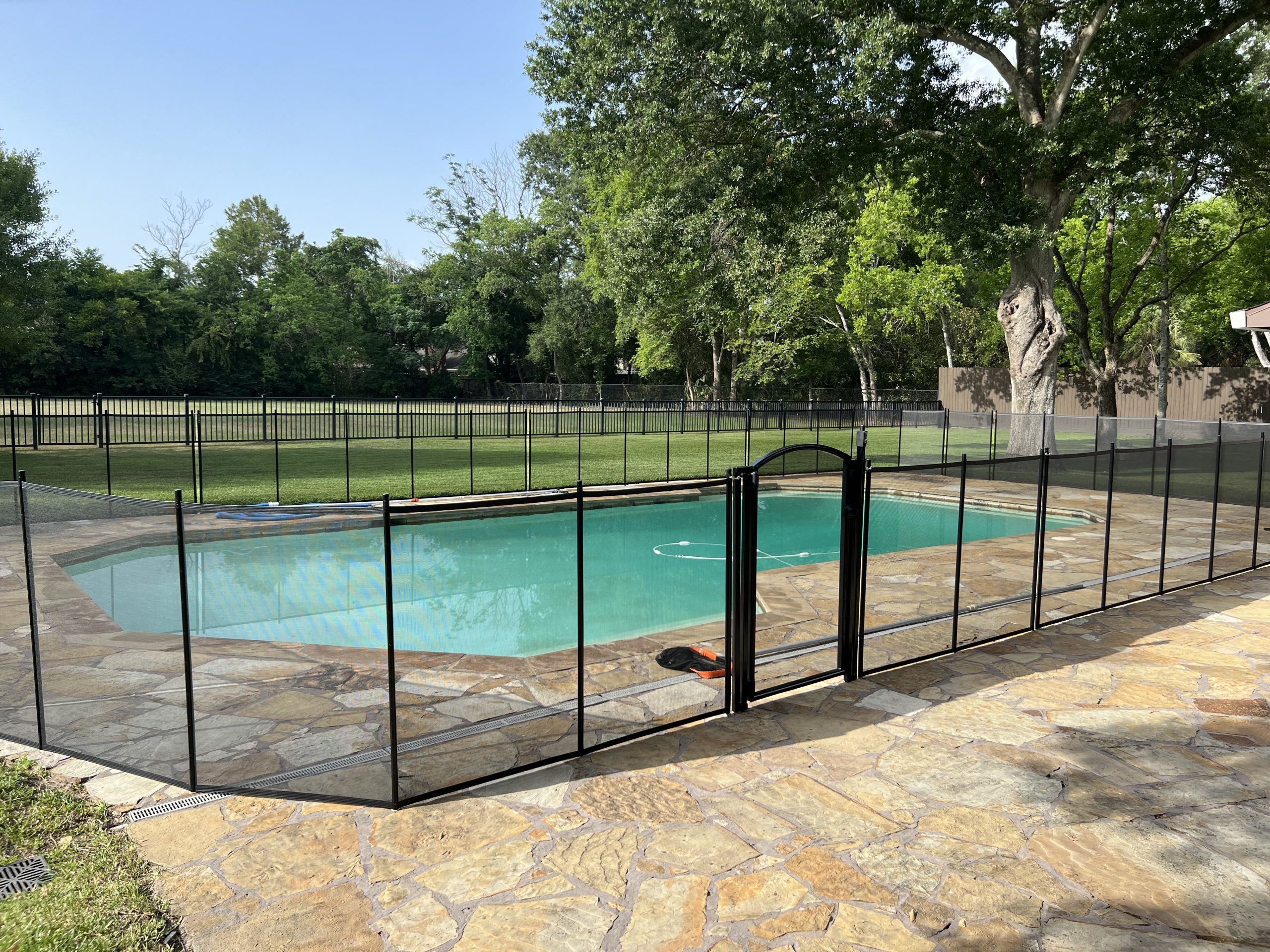 black-mesh-pool-fence-with-arched-pool-gate-katy-tx-scaled